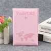 Pink leather passport holder with a faint world map design and a small airplane icon