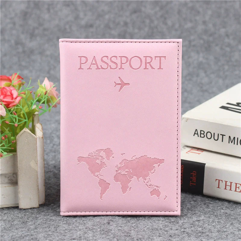 Pink leather passport holder with a faint world map design and a small airplane icon