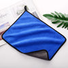 A bright blue ultra-absorbent microfiber car drying towel is displayed on a white surface.