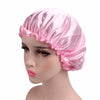 Pink satin hair bonnet displayed on a mannequin head.
