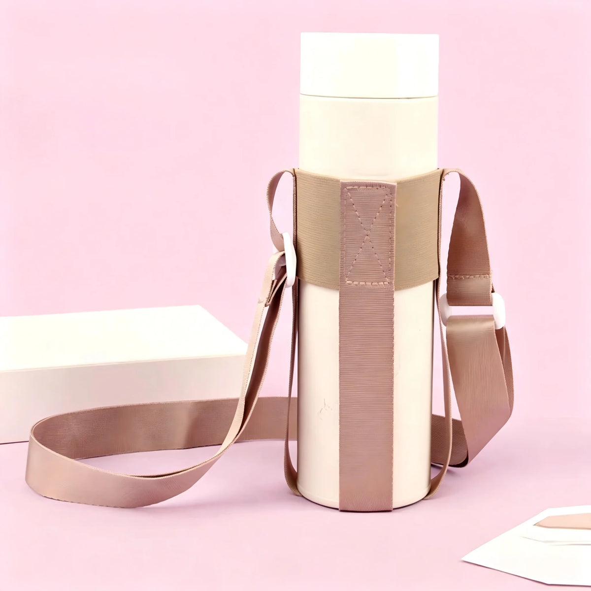 A beige breathable mesh crossbody water bottle carrier with a light pink background.