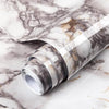 Roll of marble peel-and-stick wallpaper featuring gray and beige veining on a white background.