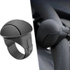 A close-up view of a black silicone steering wheel knob designed for one-hand control.