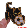 Black cat embroidered patch with glowing green eyes and a soccer ball design