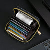 A black zippered card holder wallet is open, displaying several credit cards and a roll of cash inside.