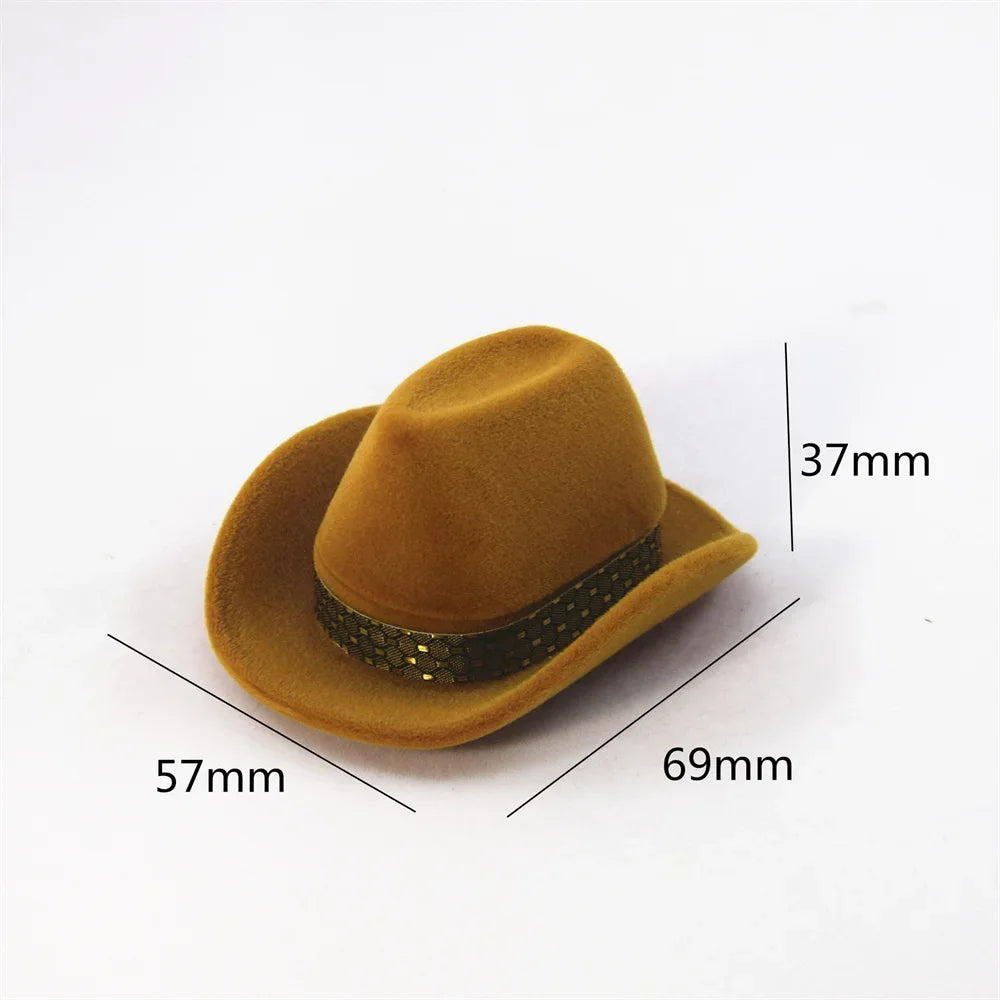 A tan felt cowboy hat with a dark band and gold accents, shown from the side.