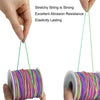 Hands hold a spool of colorful stretchy string used for jewelry making
