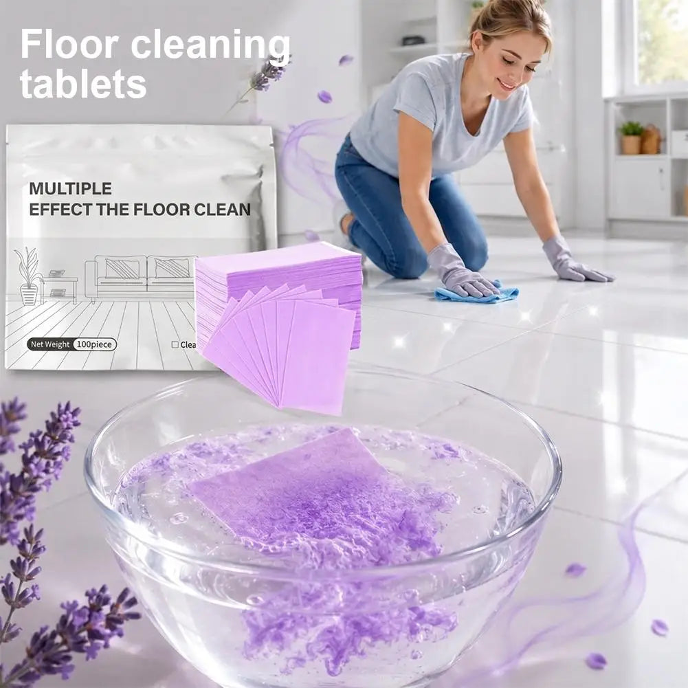 A glass bowl filled with purple cleaning tablets and soapy water on a glossy floor.