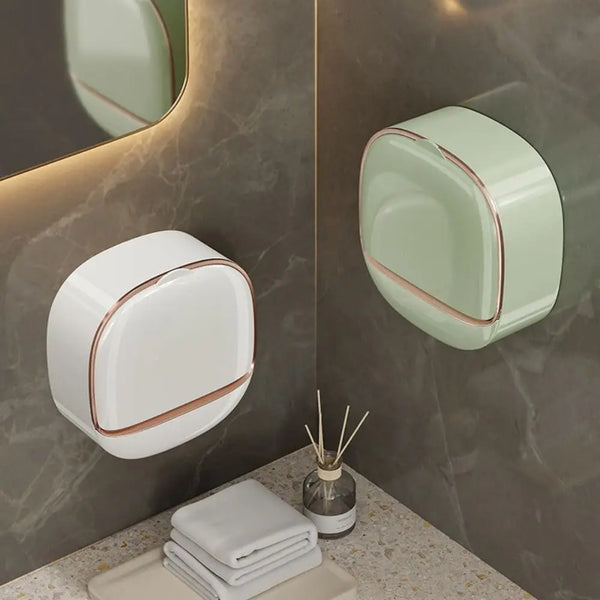 A light green wall mounted soap dish with a rounded design is displayed on a marble surface.
