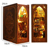A wooden DIY book nook kit featuring a detailed miniature bookshelf room scene with an arched window and various decorative e