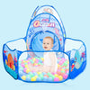 A blue ball pit play tent with a crawl tunnel is shown, featuring colorful balls and an aquatic theme.