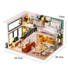 A miniature wooden dollhouse building kit featuring furniture and interior decor.