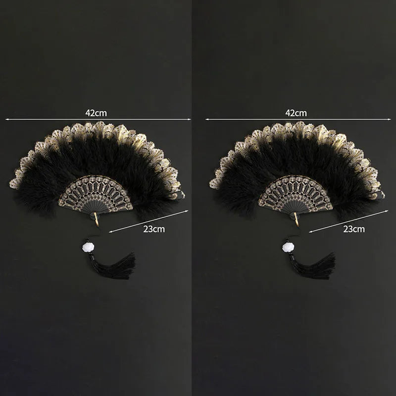 A pair of vintage folding fans with black feathers and golden lace trim shown against a dark background.