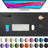 A black desk pad featuring a monitor, keyboard, mouse, and a leather notebook, surrounded by various colored circles.