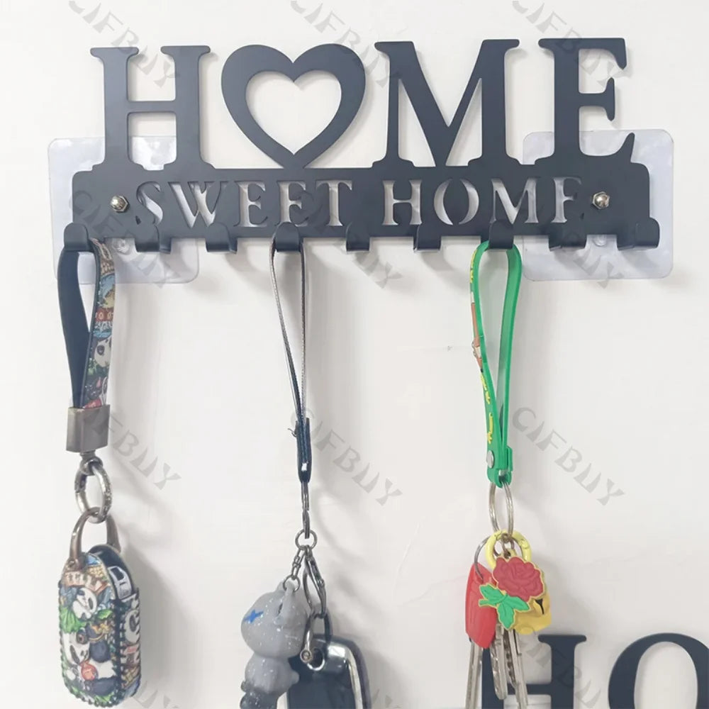 Rustic iron wall hooks for keys and coats with a heart-shaped sign displaying sweet home