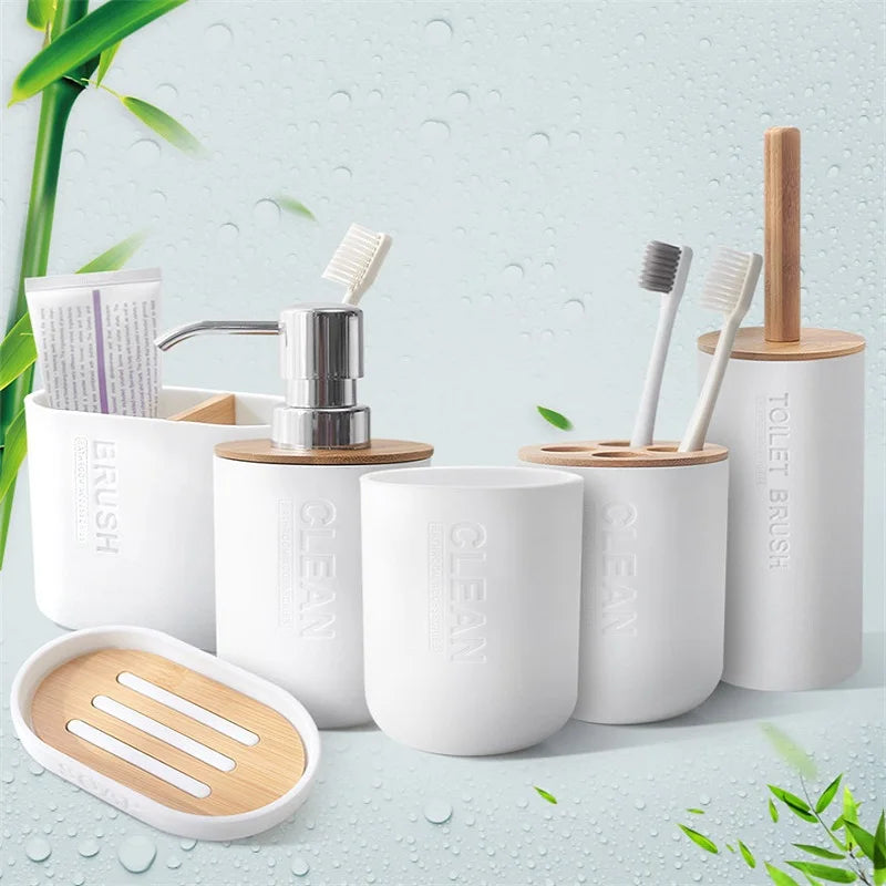 A set of white bamboo bathroom organizers and brushes with a soap dispenser on a light green background.