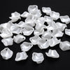 A pile of 100 clear acrylic pearl spacer beads for jewelry making