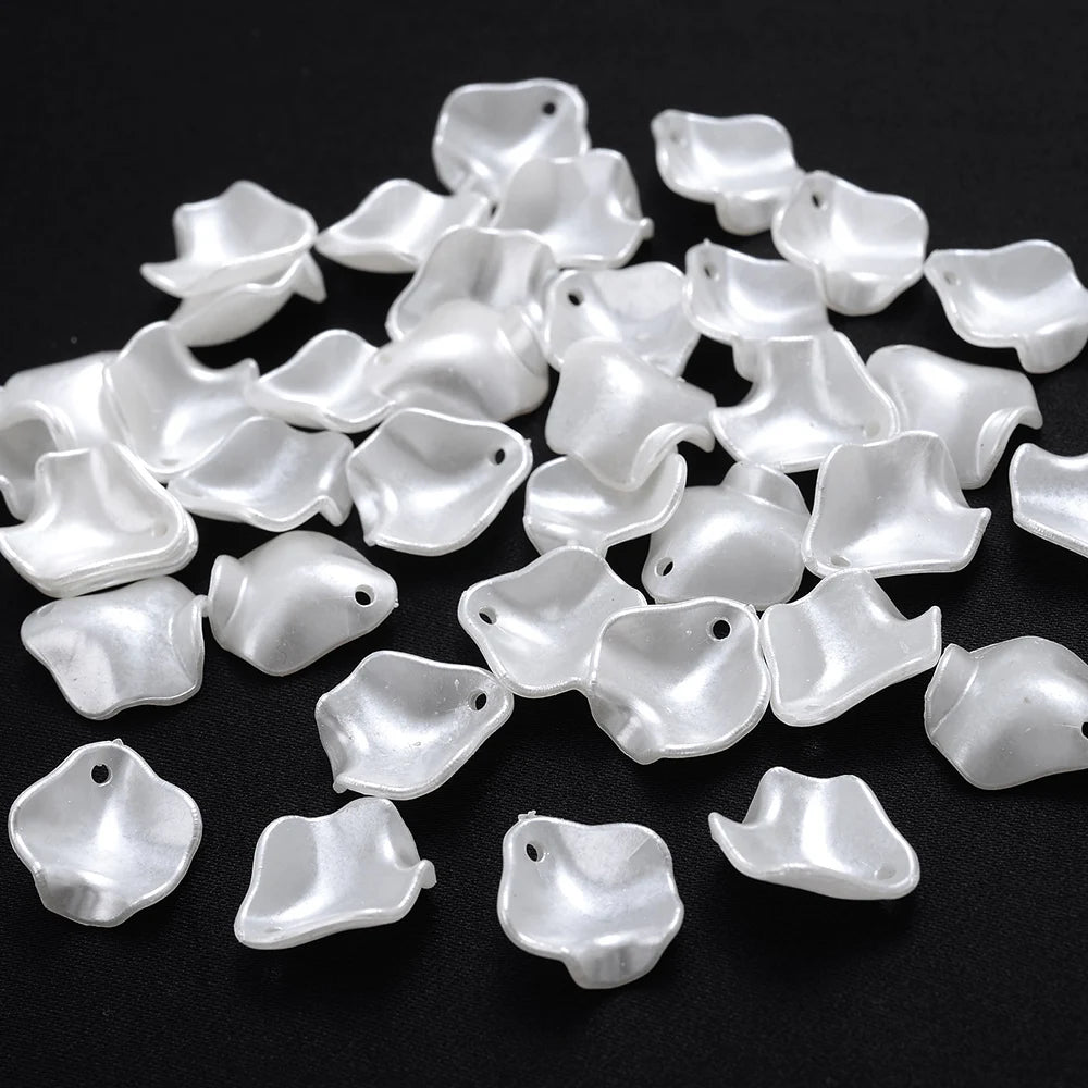 A pile of 100 clear acrylic pearl spacer beads for jewelry making
