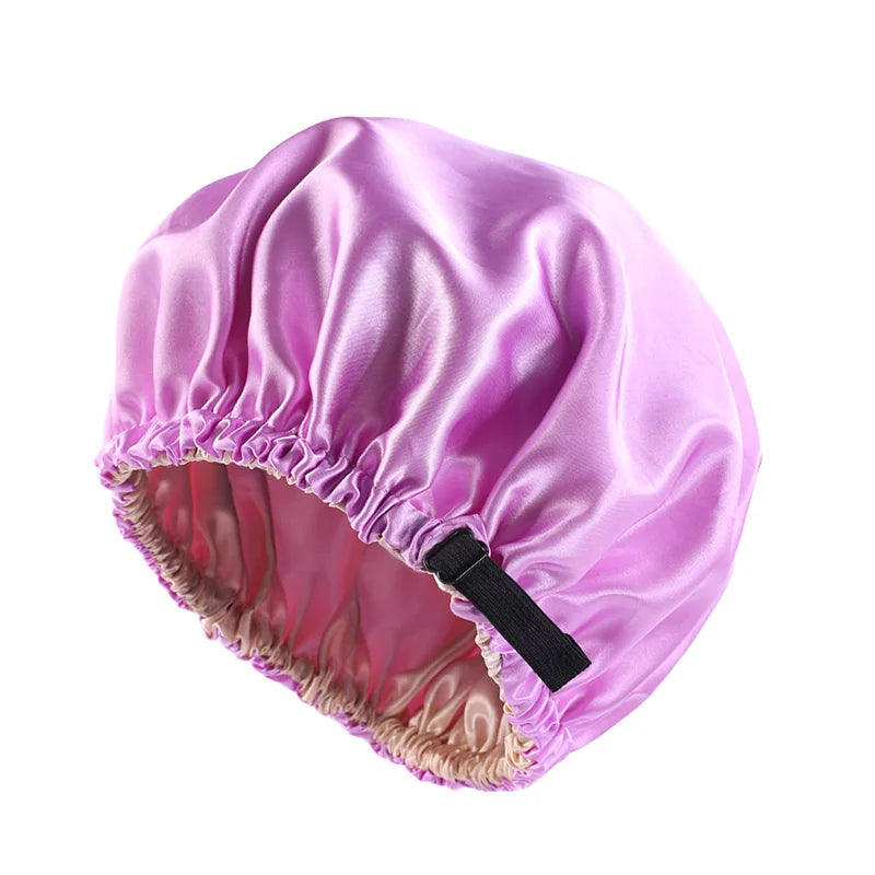 A vibrant purple satin sleep bonnet with a gathered edge and a black tie.