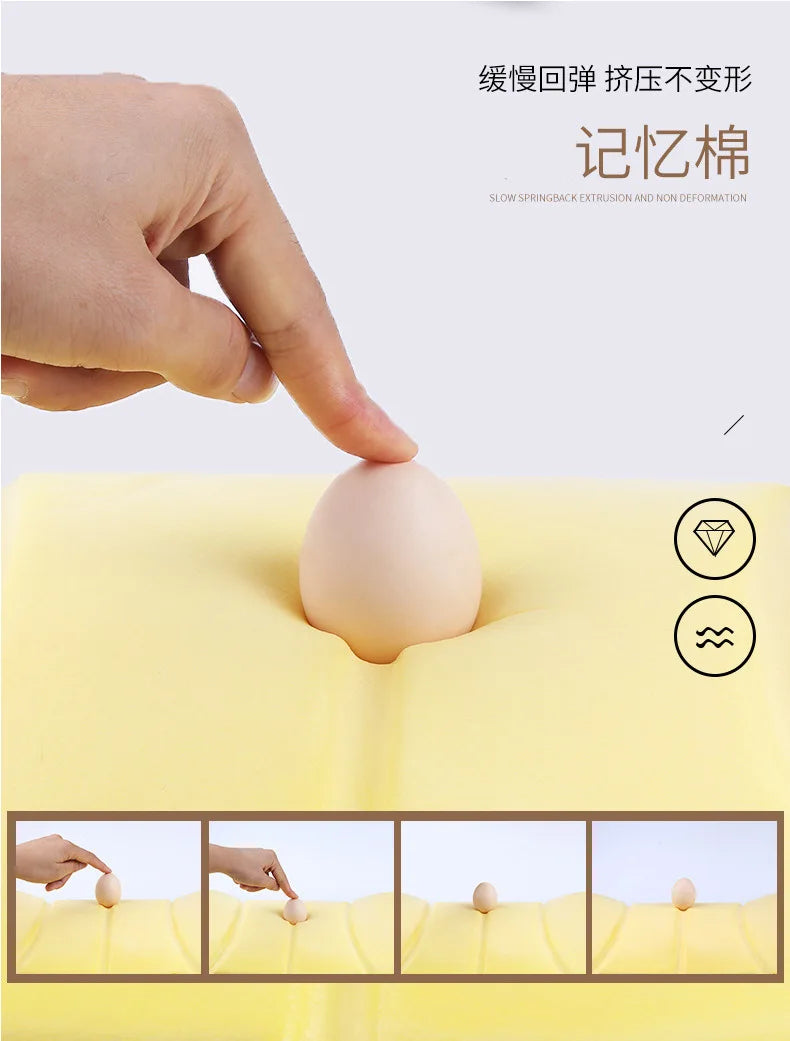 A hand presses a smooth, beige memory foam headrest pillow into a yellow car seat cushion to demonstrate its non-deformation.