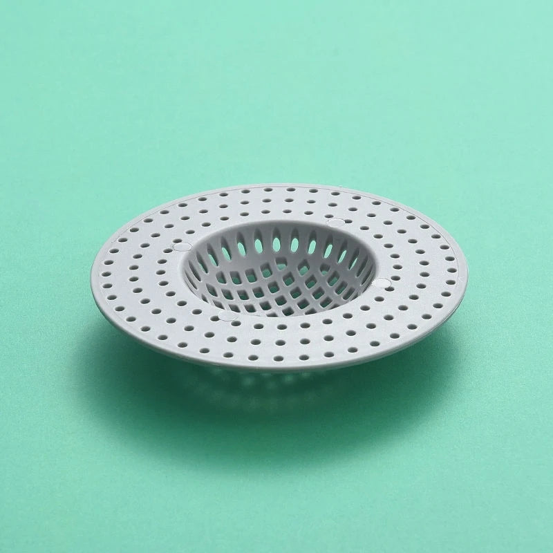 A circular silicone sink drain filter strainer with a perforated mesh design, viewed from above.