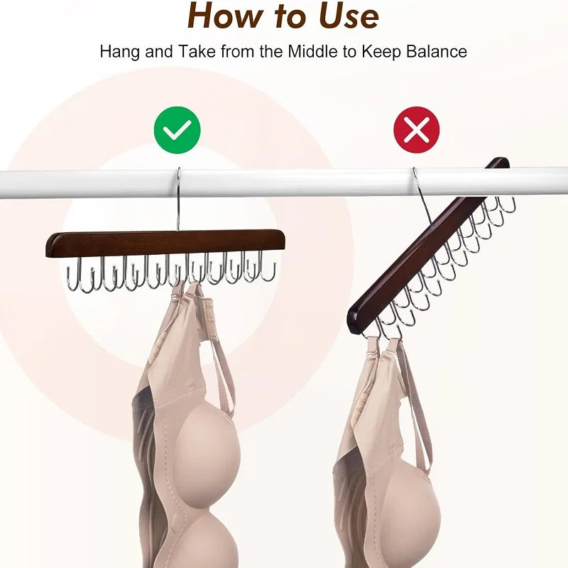 A wooden hanging organizer is shown with a hat and a belt hanging from it to keep balance.