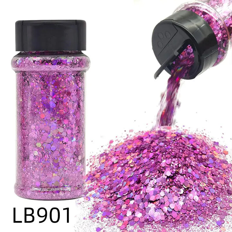 A purple holographic chunky nail glitter mix in a glass shaker bottle being poured out onto a surface.