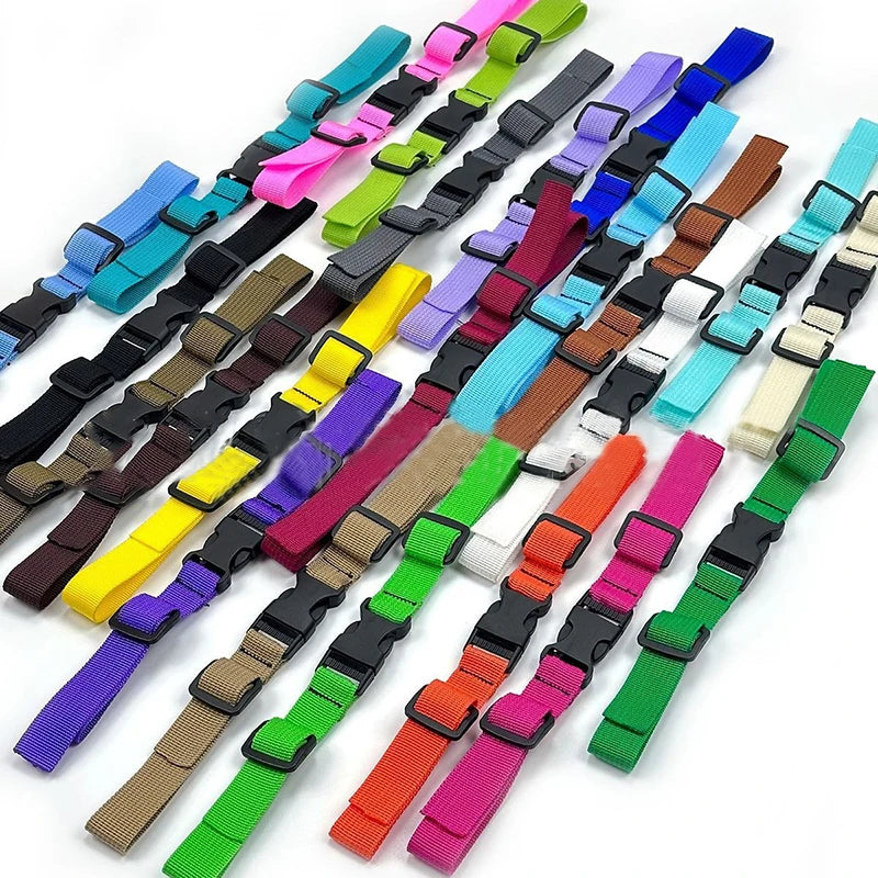 A variety of colorful adjustable backpack chest straps are displayed in a row.