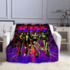 A purple and pink printed flannel throw blanket featuring the Kiss band members in dynamic poses.