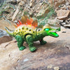 A green and orange interactive walking T-Rex dinosaur toy with glowing eyes standing on a rock.