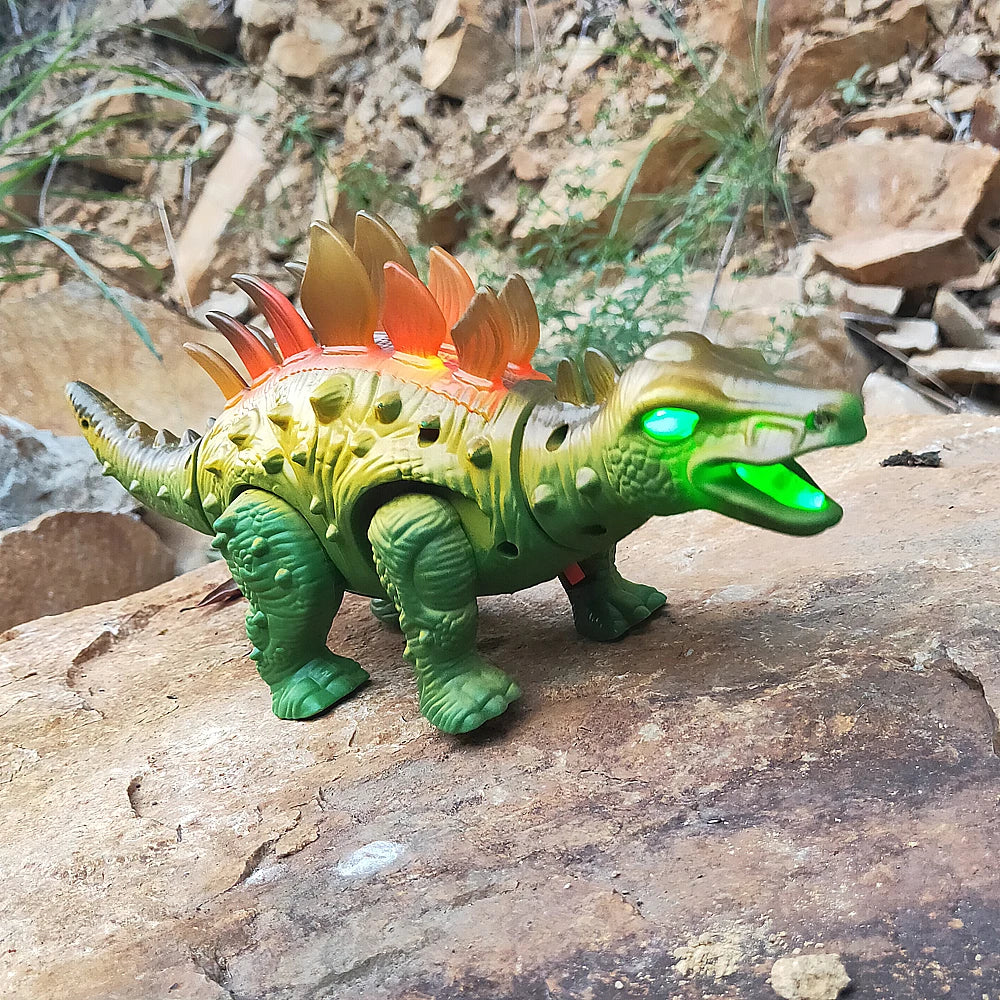 A green and orange interactive walking T-Rex dinosaur toy with glowing eyes standing on a rock.