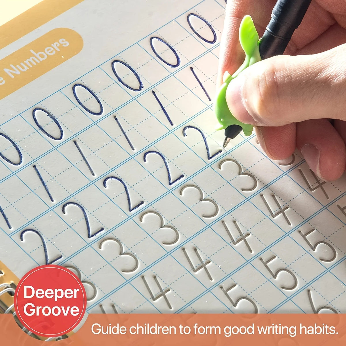 A hand writes numbers and letters in a grid-lined practice book with a green pen.