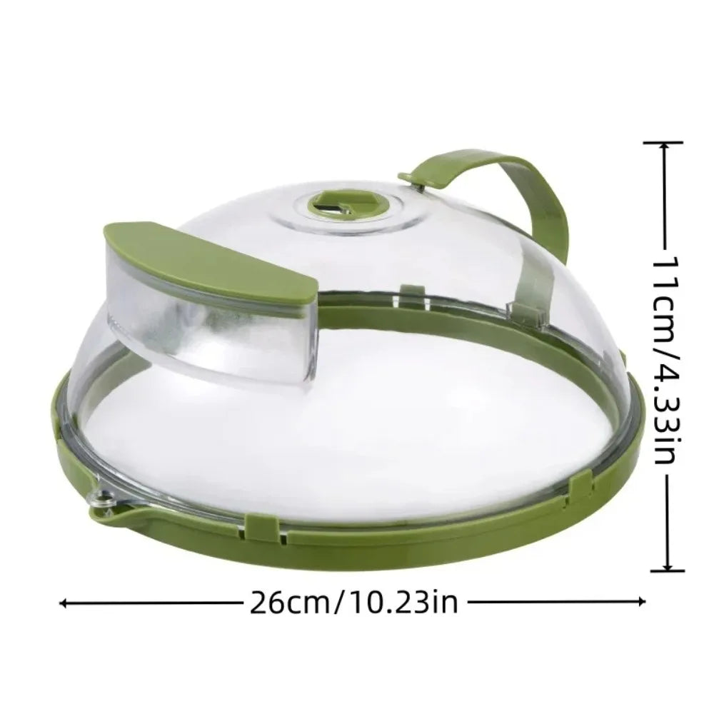 A clear microwave splatter cover with a green handle and steamer insert shown from above.