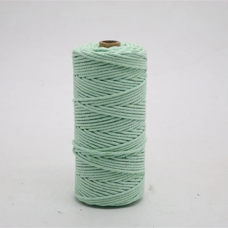 A spool of light mint green macrame cord for crafting, measuring 3mm/4mm and 100 meters long.