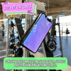 A smartphone is mounted on a silicone suction cup device, positioned for hands-free viewing in a gym or fitness setting.