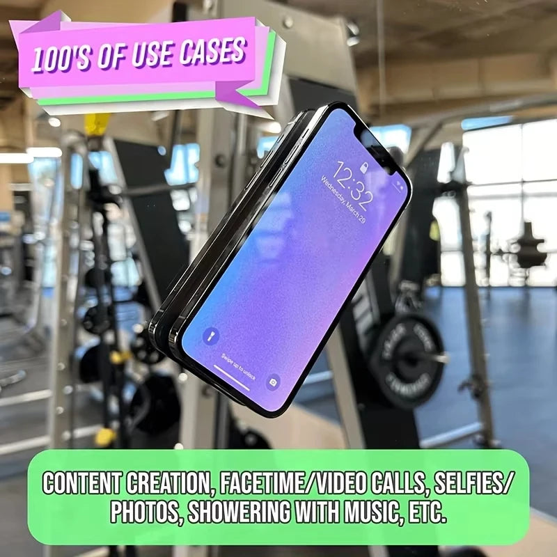 A smartphone is mounted on a silicone suction cup device, positioned for hands-free viewing in a gym or fitness setting.