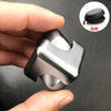A hand holds a silver alloy metal fidget cube spinner, showing its texture and design.