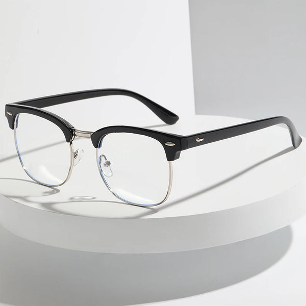 A pair of black retro half-frame blue light blocking glasses resting on a white surface.