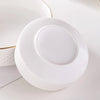 A white ceramic soup bowl with a lid is shown on a white surface.