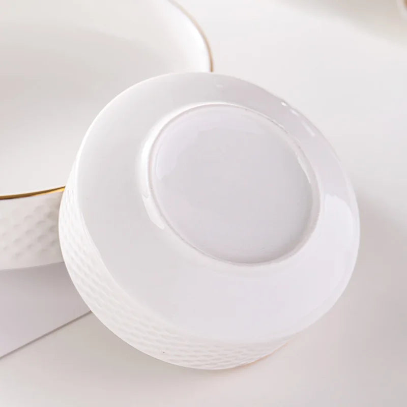 A white ceramic soup bowl with a lid is shown on a white surface.