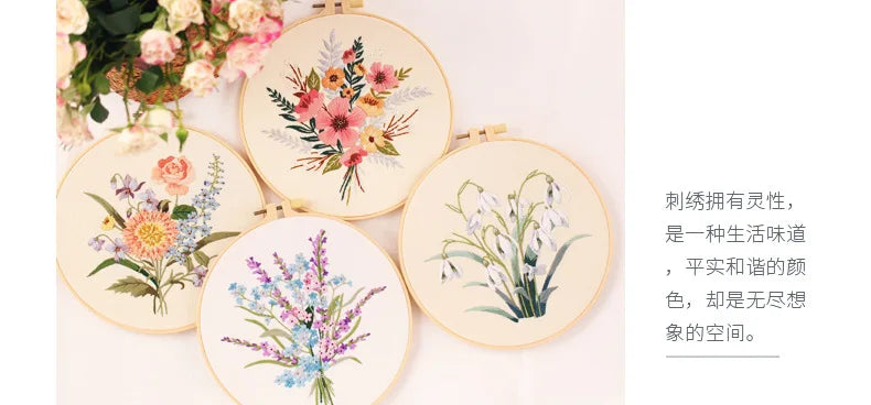 A collection of five round embroidery pieces featuring floral designs in soft pastel colors on cream fabric.