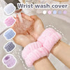 Hands are shown using a pink wrist wash cover product in a bathroom setting.