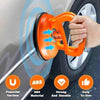 Orange suction cup tool demonstrating powerful suction on a car body surface for dent pulling.