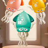 Three colorful octopus toys in pink, yellow, and green are displayed against a light background.