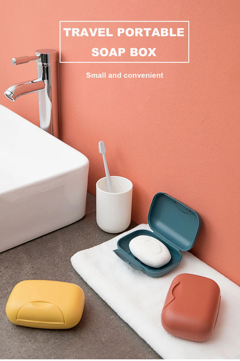 A small, leak-proof travel soap box in orange and yellow sits on a white towel next to a sink.