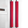 A close-up of two red velvet anti-skid handle covers hanging on a refrigerator door.
