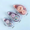Pink double-sided adhesive tape roller with a clear plastic casing and measuring markings