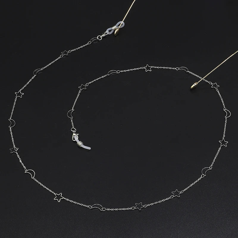 Silver chain necklace featuring a star and moon pendant design