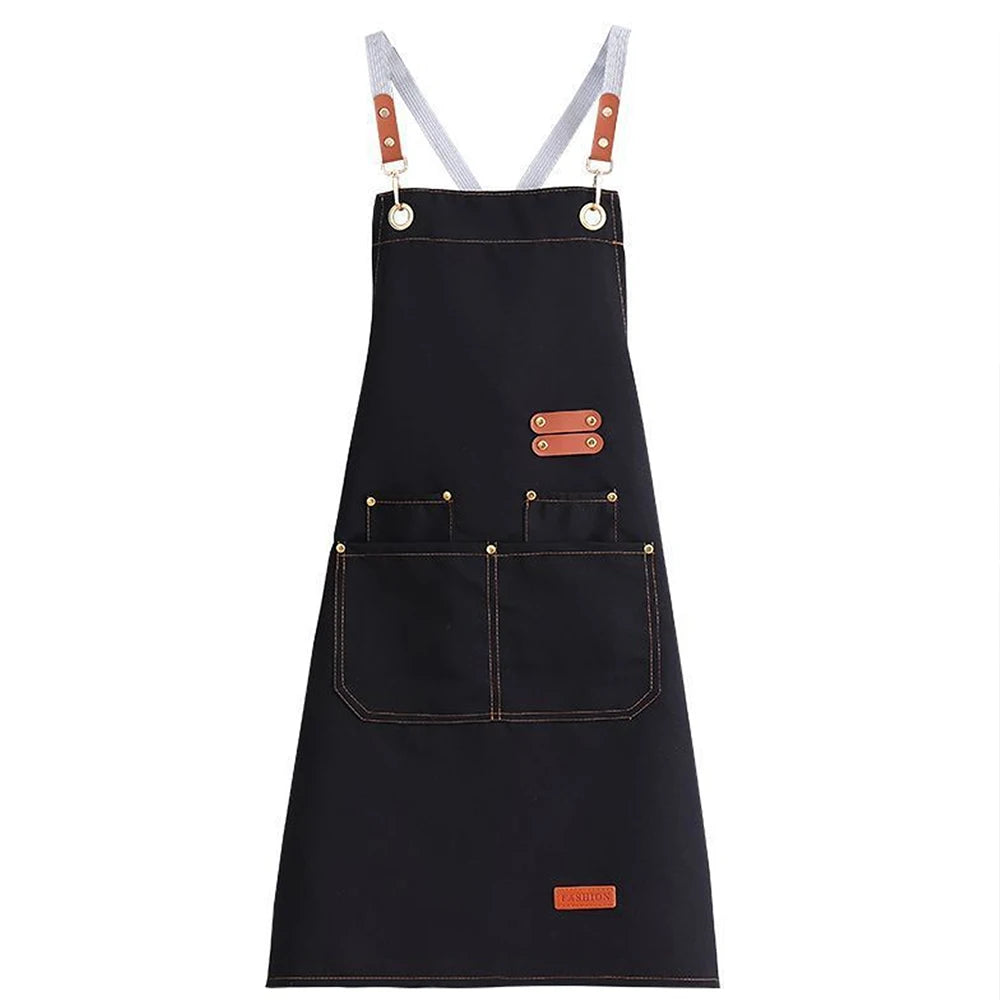 A dark navy canvas kitchen apron with light gray straps and large pockets.