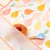 A pink and yellow patterned feeding bib with a wooden fork is shown on a light background.